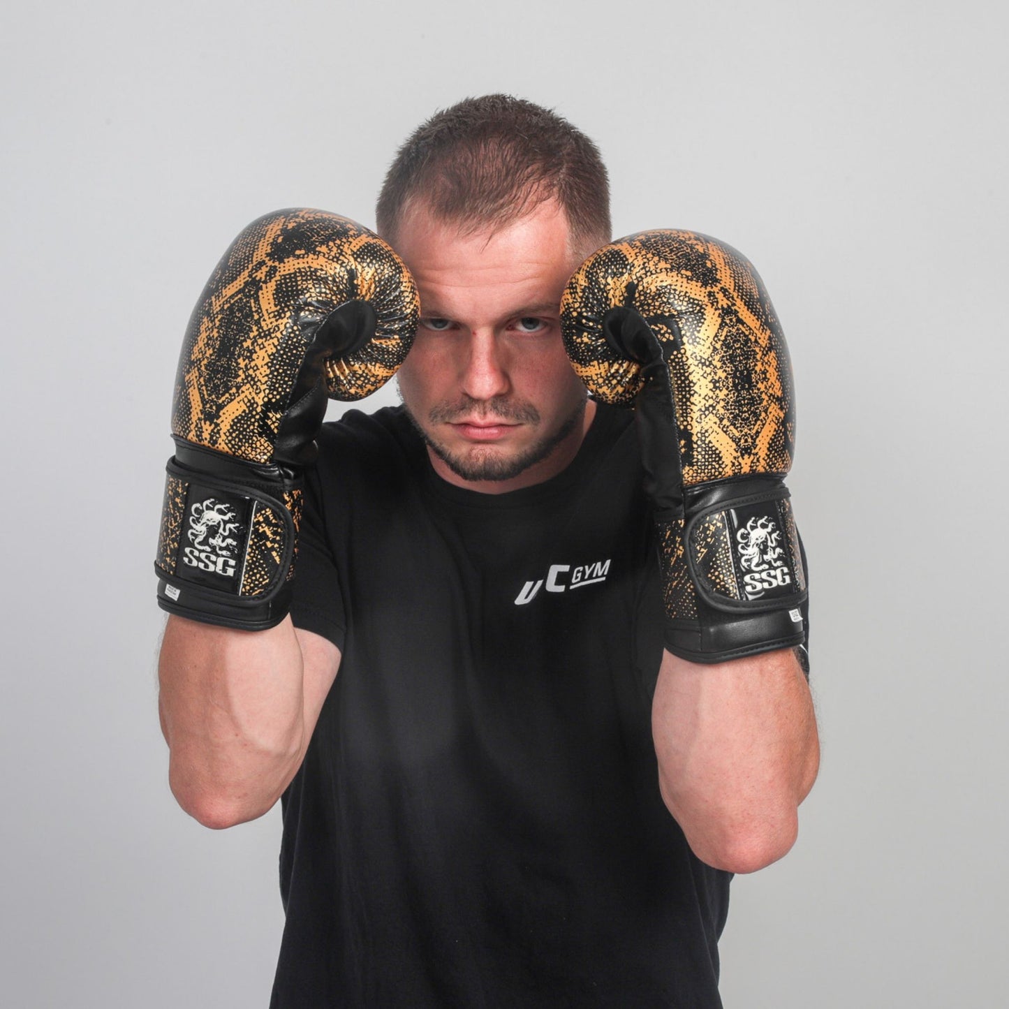 Model wearing Midnight Strike boxing gloves in training stance – StoneStrikeGear lifestyle image