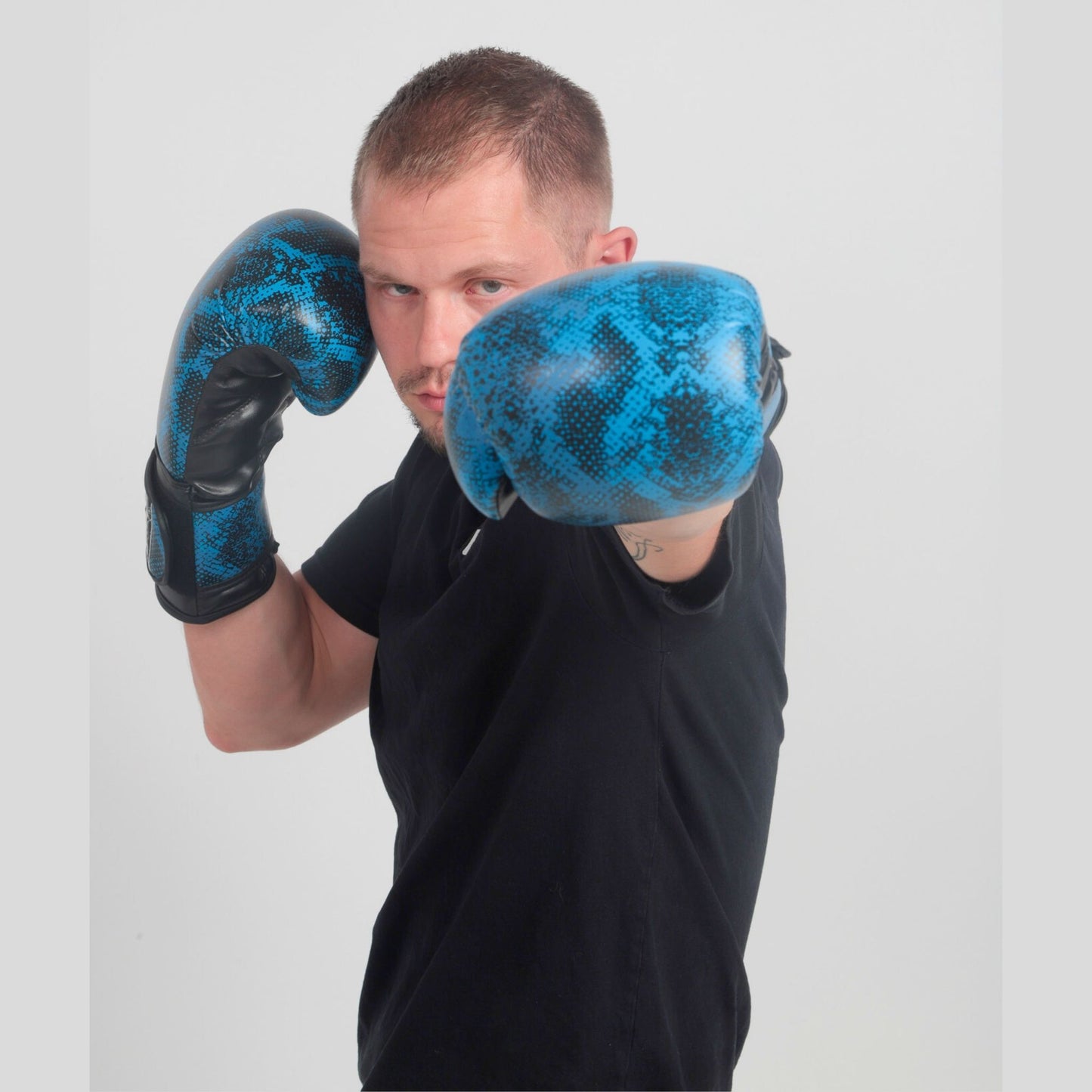 Model wearing Medusa’s Blue Gaze boxing gloves in training stance – StoneStrikeGear lifestyle image