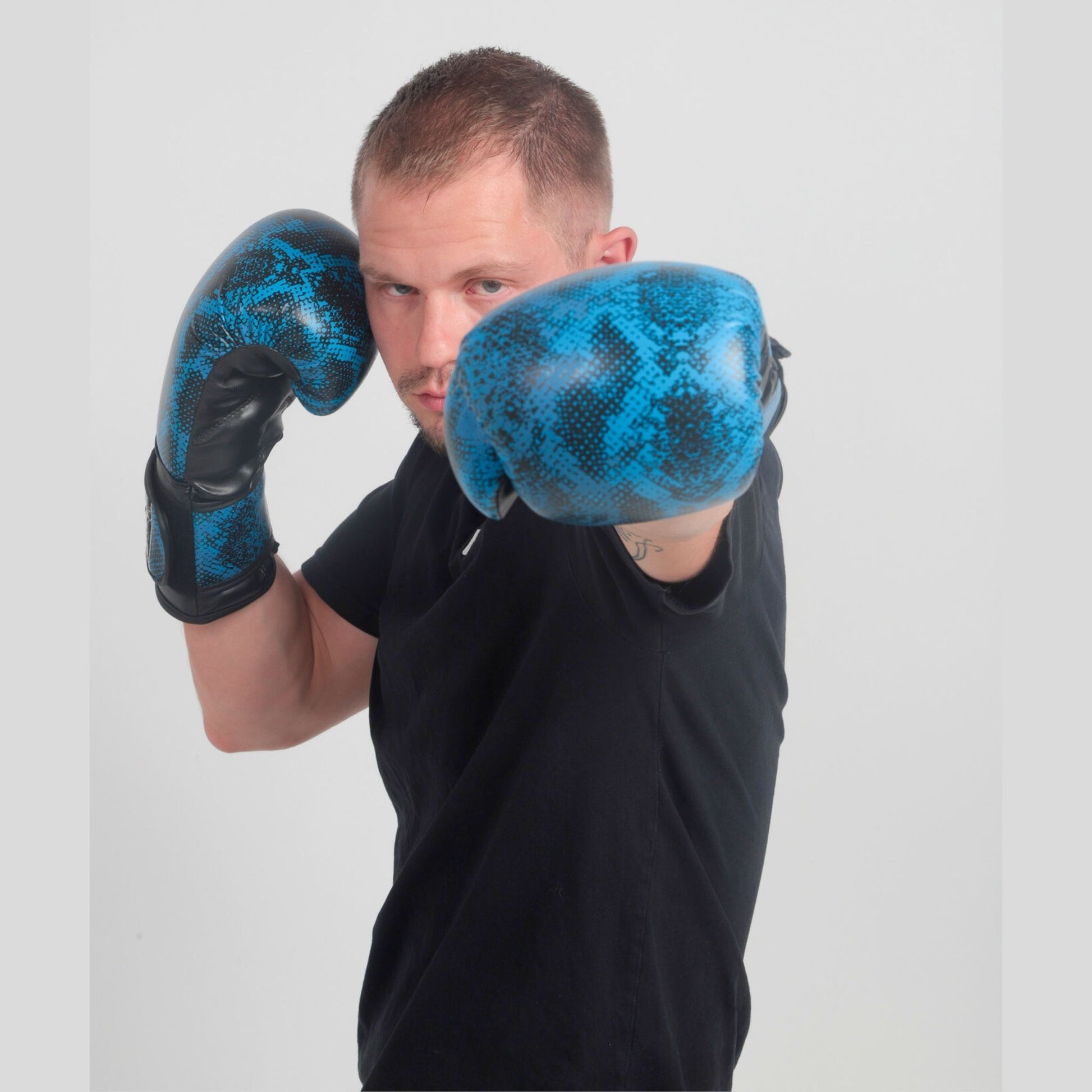 Model wearing Medusa’s Blue Gaze boxing gloves in training stance – StoneStrikeGear lifestyle image